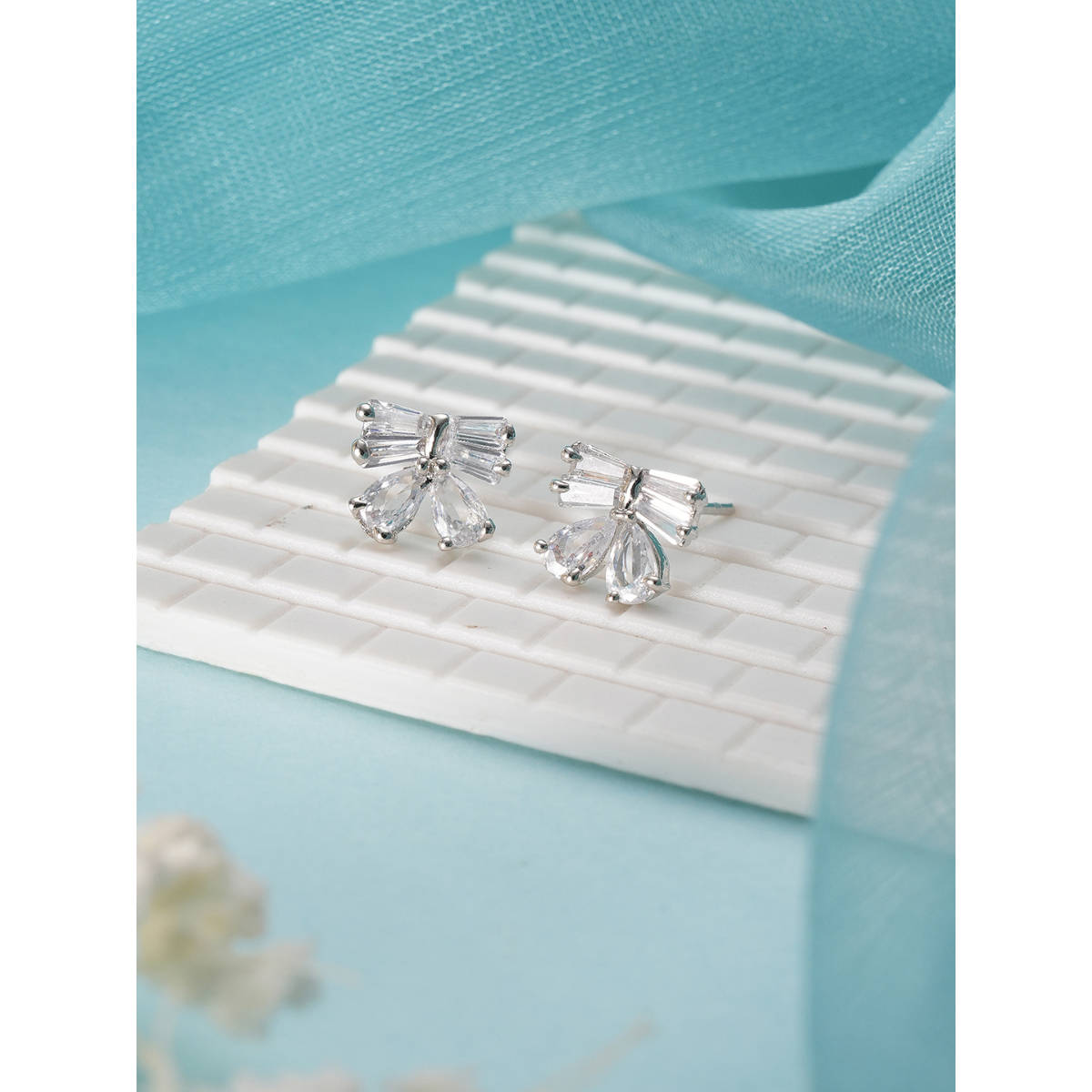 Aatmana Silver Plated American Diamond Studded Bow Shaped Contemporary Studs