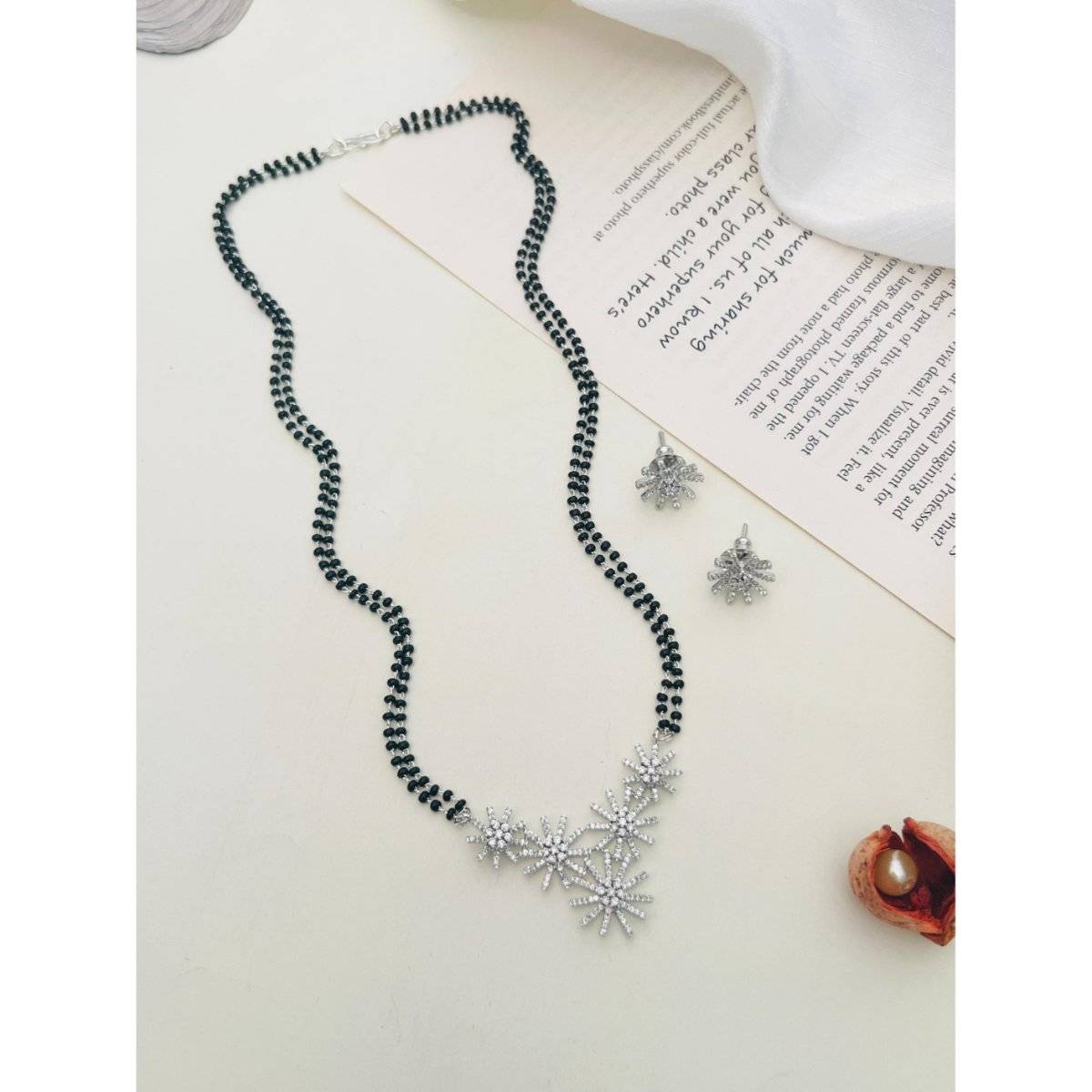 Abdesigns White Silver Plated American Diamond Studded Beaded Mangalsutra with Pair Of Earrings