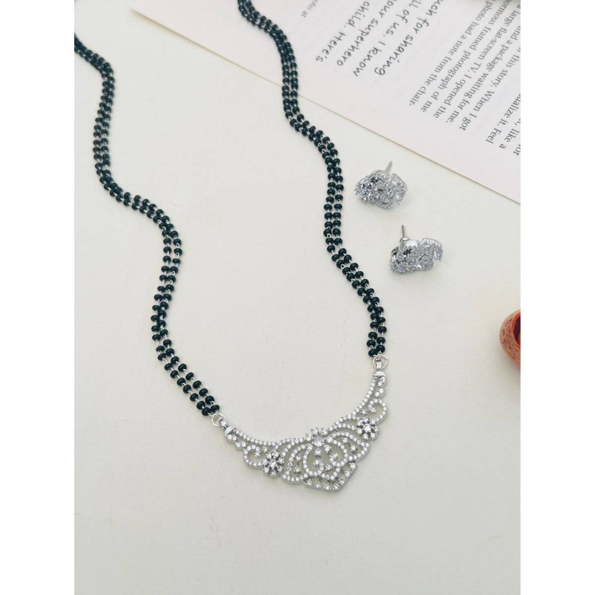 Abdesigns White Silver Plated American Diamond Studded Beaded Mangalsutra with Pair Of Earrings