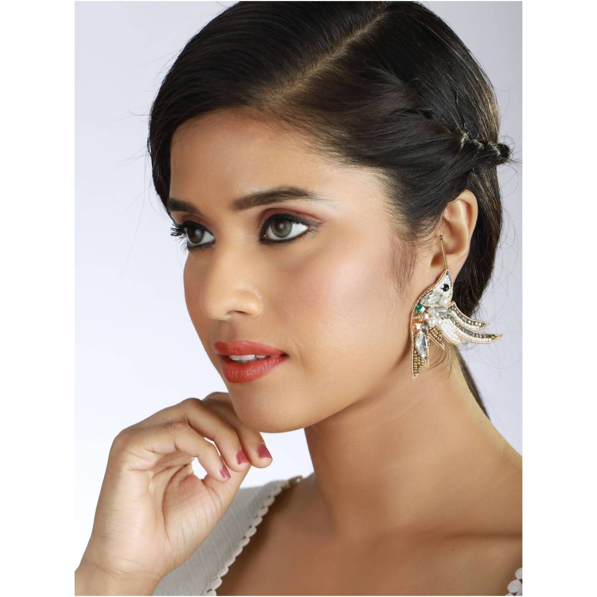 Aatmana Gold Toned Beads and White Crystals Studded Contemporary Bird Shaped Earrings